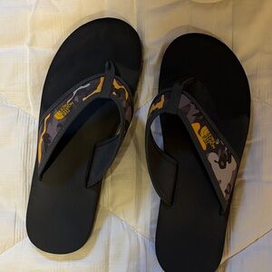The North Face Men’s Black Flip Flops with Camo & Yellow Logo
